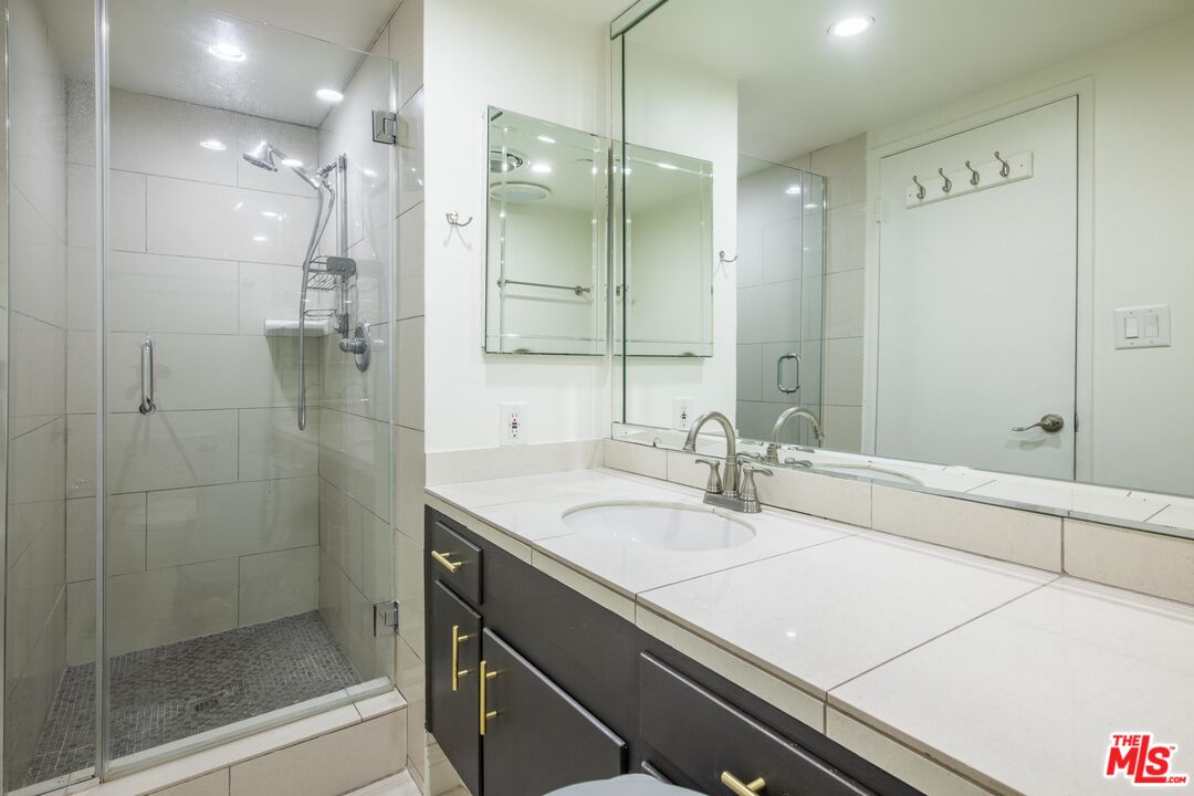 148 South Reeves Drive, Unit 4 Beverly Hills, CA 90212 - Photo 12 of 15 a bathroom with a sink shower and a mirror