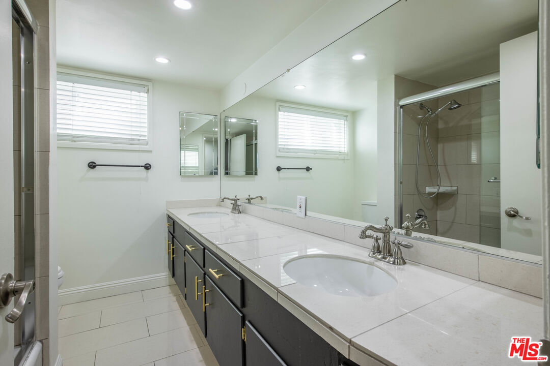 148 South Reeves Drive, Unit 4 Beverly Hills, CA 90212 - Photo 8 of 15 a bathroom with a double vanity sink a mirror and a shower
