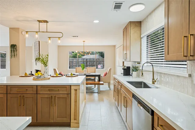 a kitchen with sink stove and cabinets