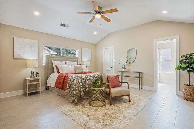 a bed room with a bed and potted plant