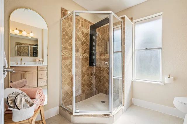 a bathroom with a shower a mirror and a sink