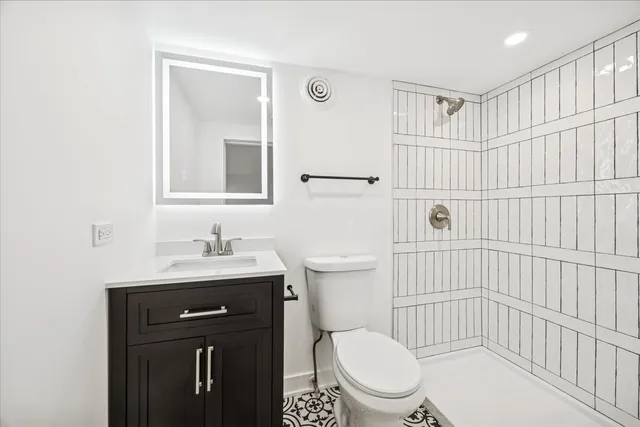 a bathroom with a sink toilet and shower