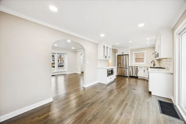 a view of a kitchen with a sink and wooden floor