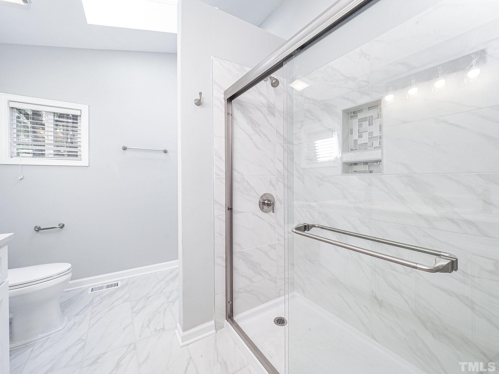 626 Winterlochen Road Raleigh, NC 27603 - Photo 11 of 16 a bathroom with a shower and a toilet