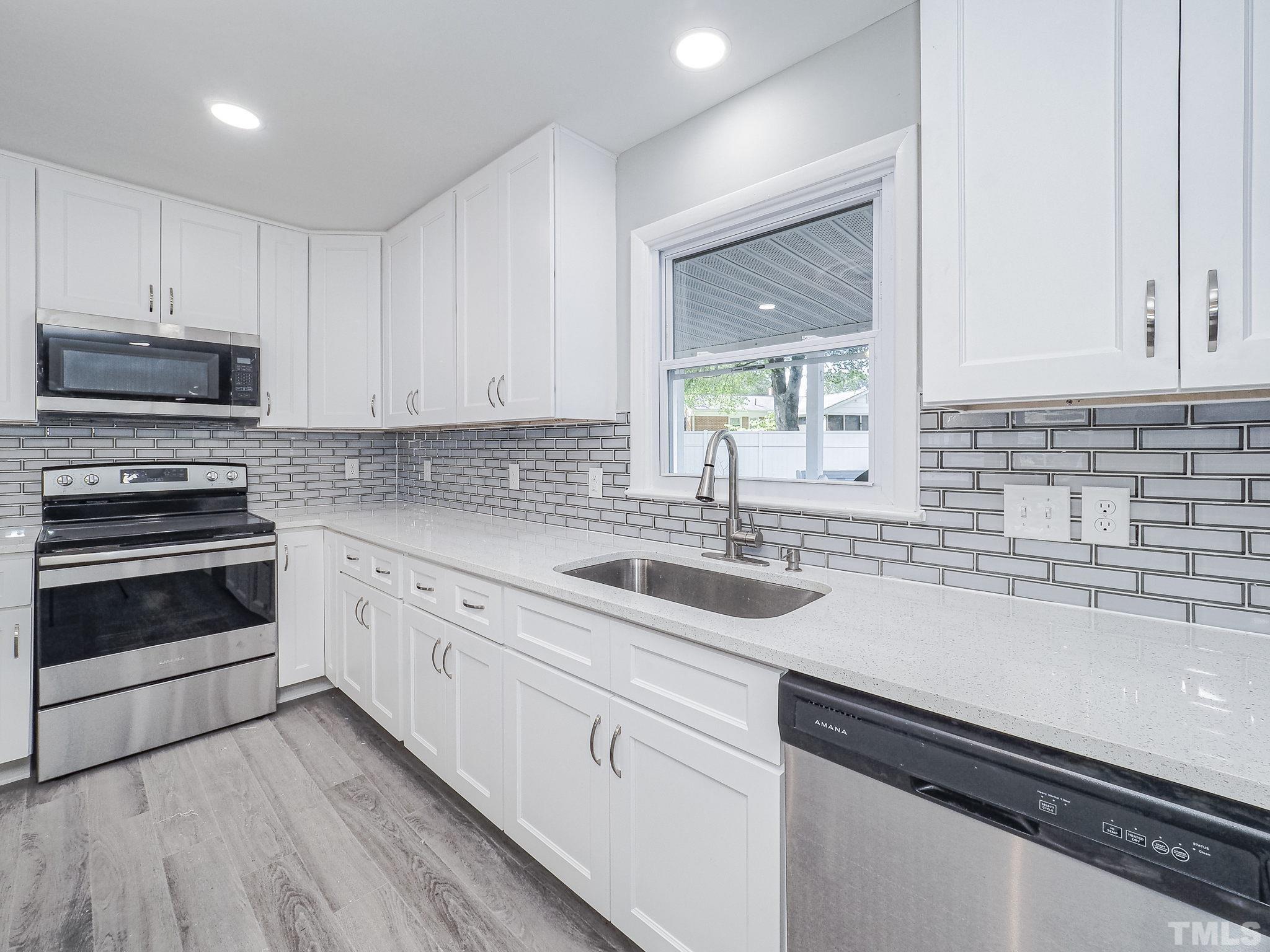 626 Winterlochen Road Raleigh, NC 27603 - Photo 4 of 16 a kitchen with sink cabinets and stainless steel appliances