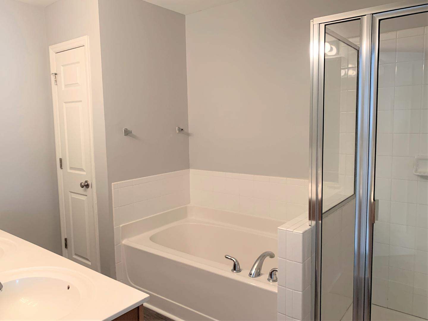 a bathroom with a tub and shower
