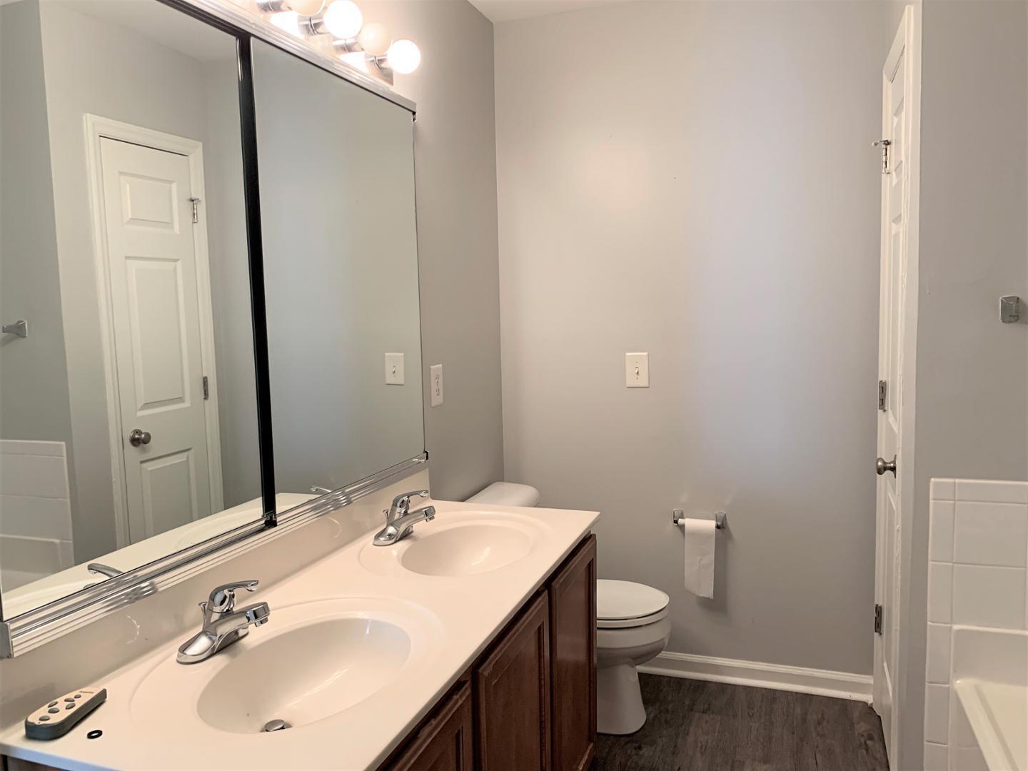 11721 Coppergate Drive, Unit 107 Raleigh, NC 27614 - Photo 2 of 5 a bathroom with a toilet a sink and mirror