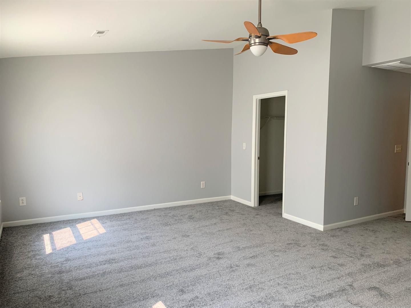 11721 Coppergate Drive, Unit 107 Raleigh, NC 27614 - Photo 3 of 5 a view of an empty room with a fan