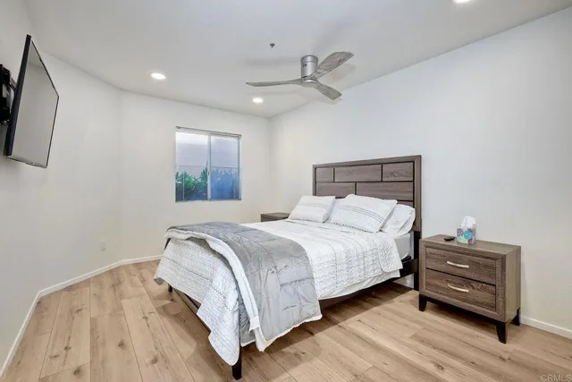 a bedroom with a bed and wooden floor