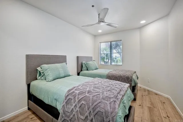 a bedroom with a large bed and a chandelier