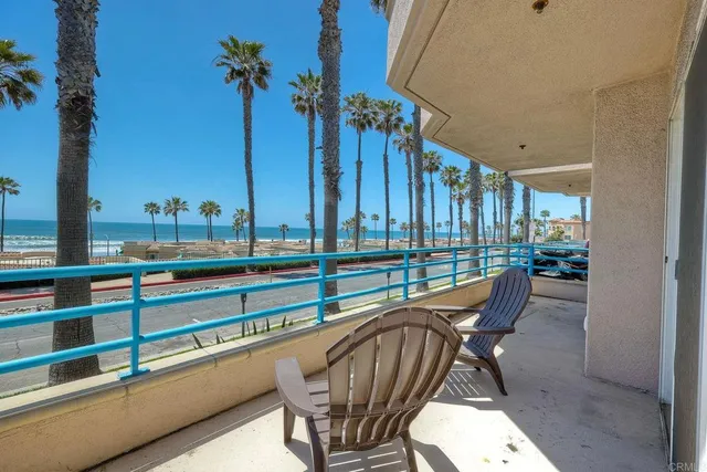 a view of a chairs and table in patio with a swimming pool