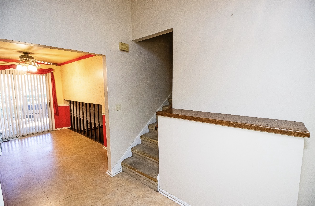 911 Colonade Road Shorewood, IL 60404 - Photo 15 of 36 a view of a hallway with wooden floor and staircase