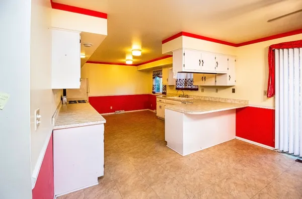 a kitchen with kitchen island a sink stove and wooden cabinets