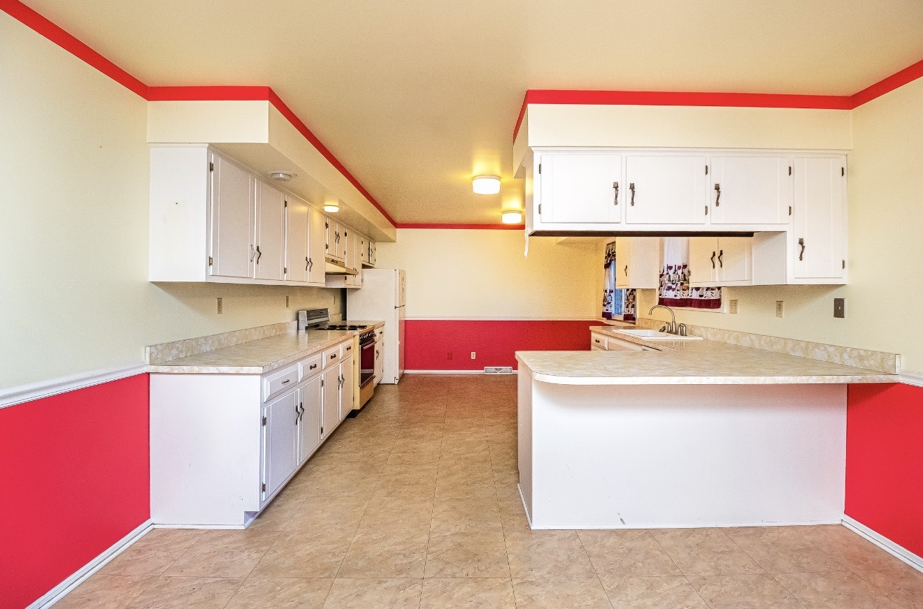 911 Colonade Road Shorewood, IL 60404 - Photo 17 of 36 a kitchen with kitchen island a sink stove and wooden cabinets