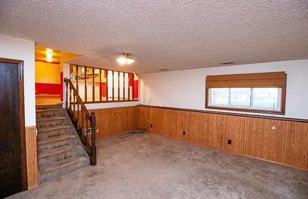a room with a wooden floor and cabinets