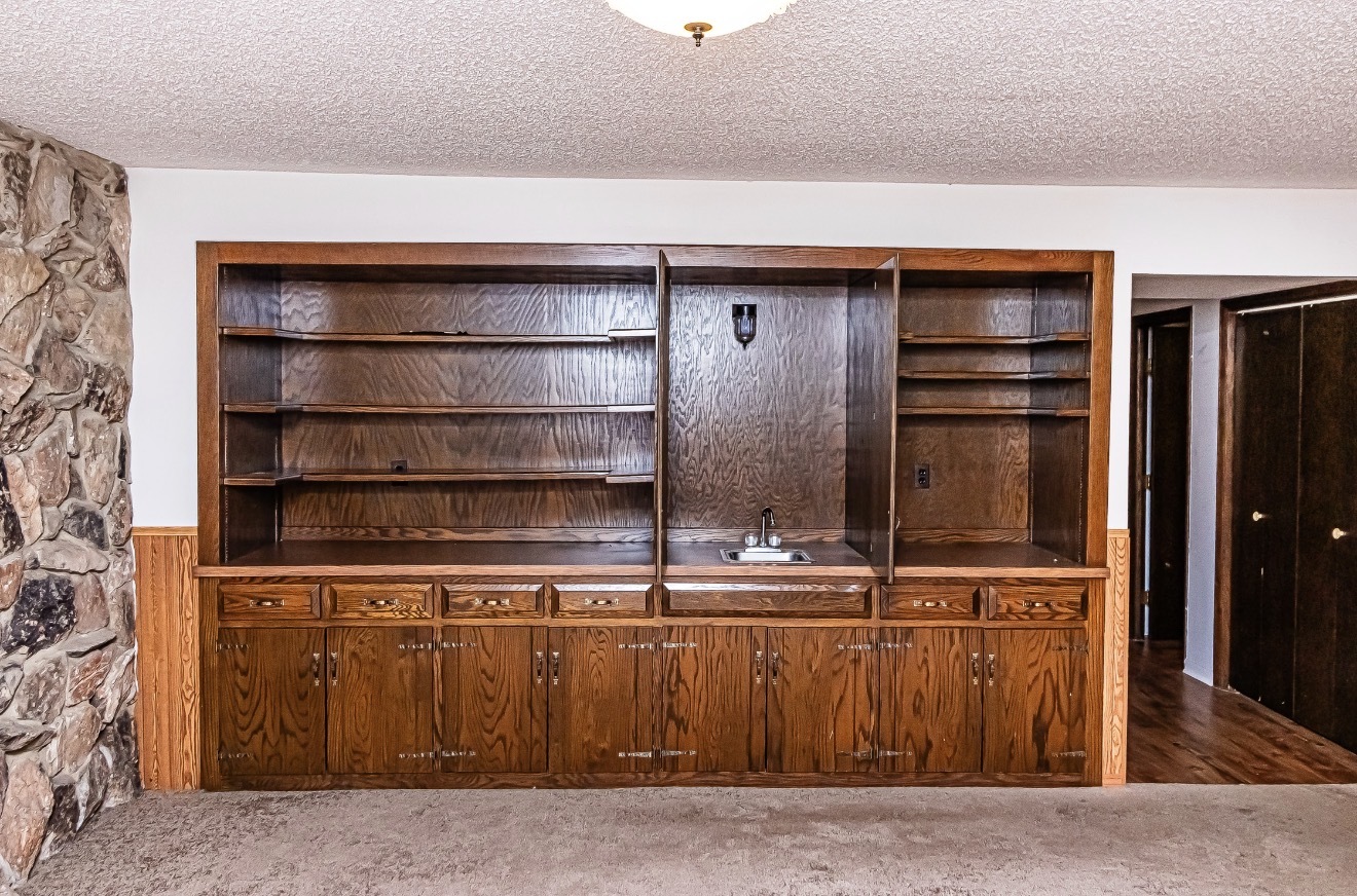 911 Colonade Road Shorewood, IL 60404 - Photo 24 of 36 a room with a wooden floor and cabinets