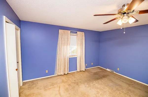 a view of a room with wooden floor and windows