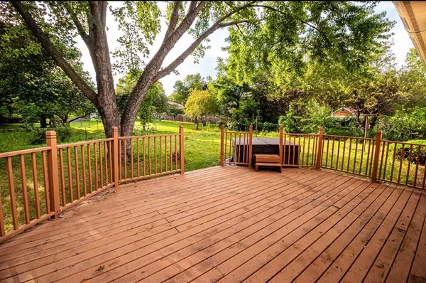 a deck view with a wooden floor next to a yard