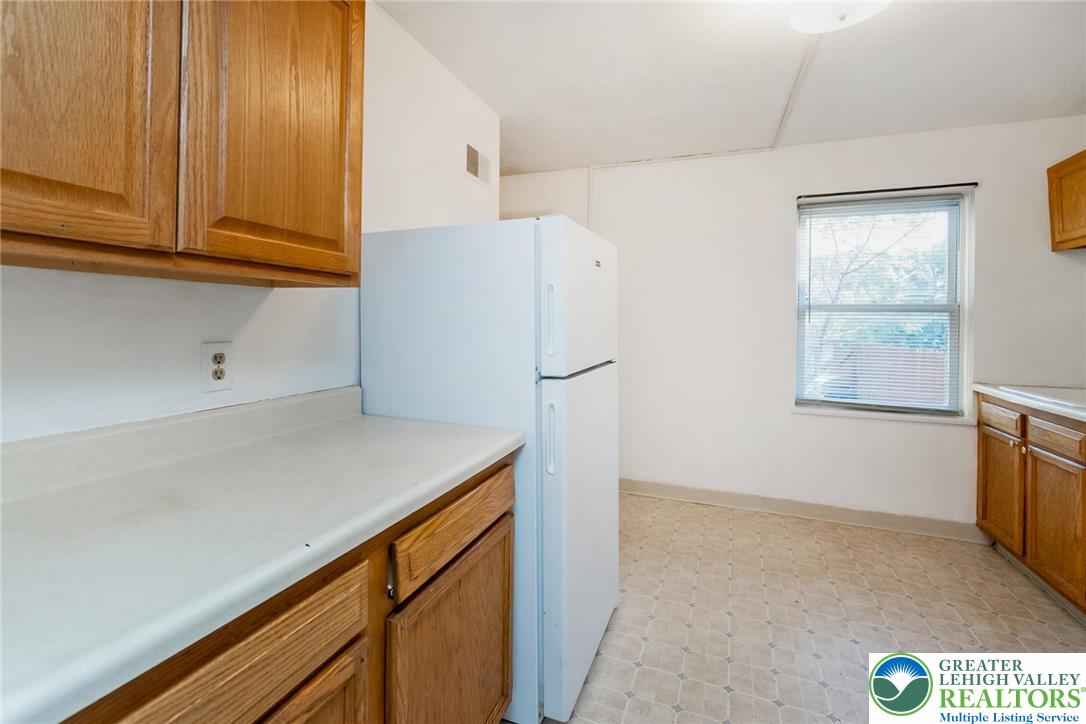 240 Palmer Street Easton, PA 18042 - Photo 13 of 37 a kitchen with stainless steel appliances a refrigerator and a window