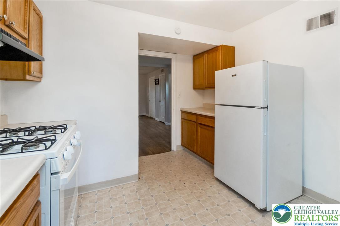 240 Palmer Street Easton, PA 18042 - Photo 15 of 37 a kitchen with a stove a refrigerator and a sink