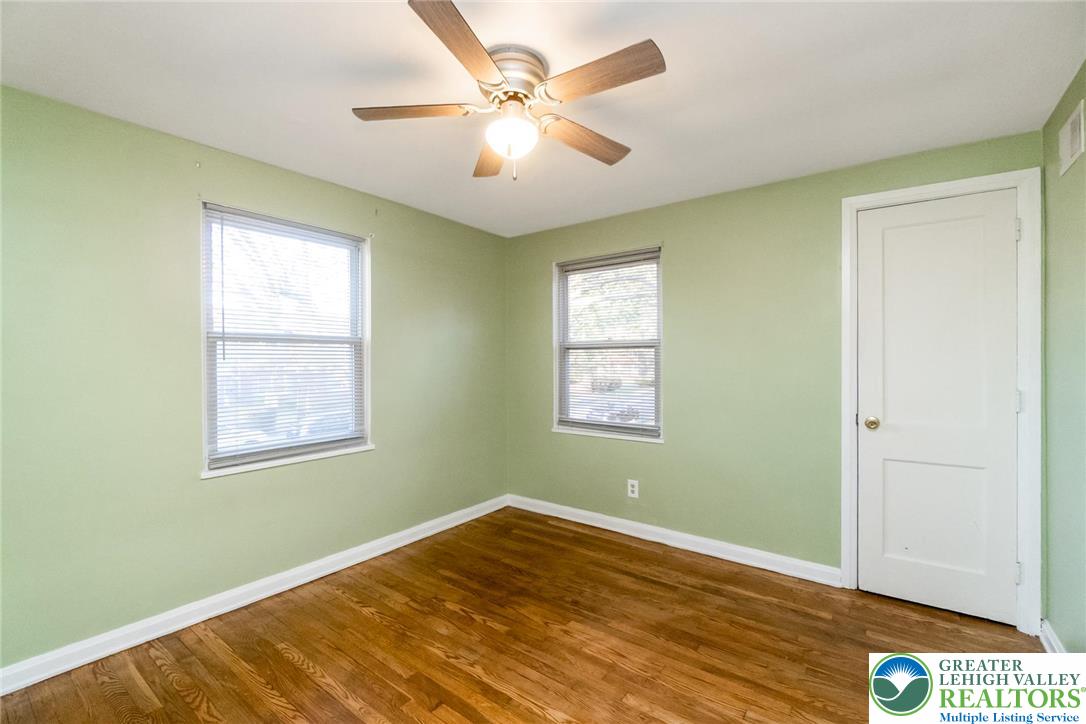240 Palmer Street Easton, PA 18042 - Photo 21 of 37 a view of an empty room with wooden floor and a window