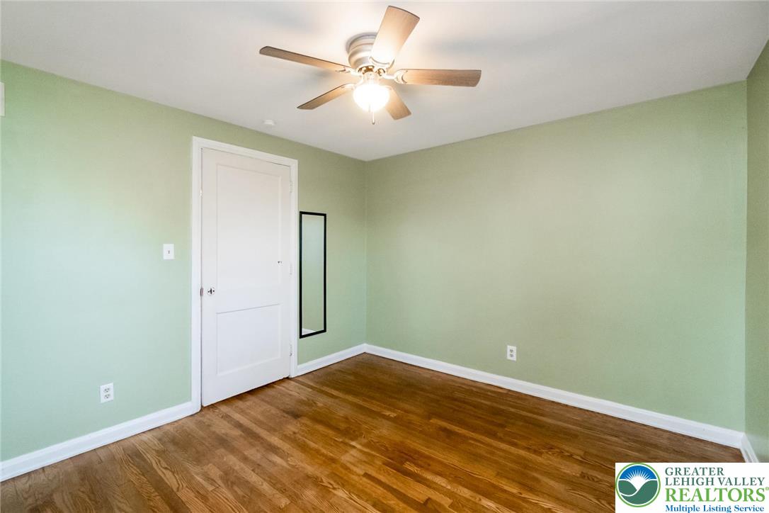 240 Palmer Street Easton, PA 18042 - Photo 23 of 37 an empty room with a chandelier fan and windows
