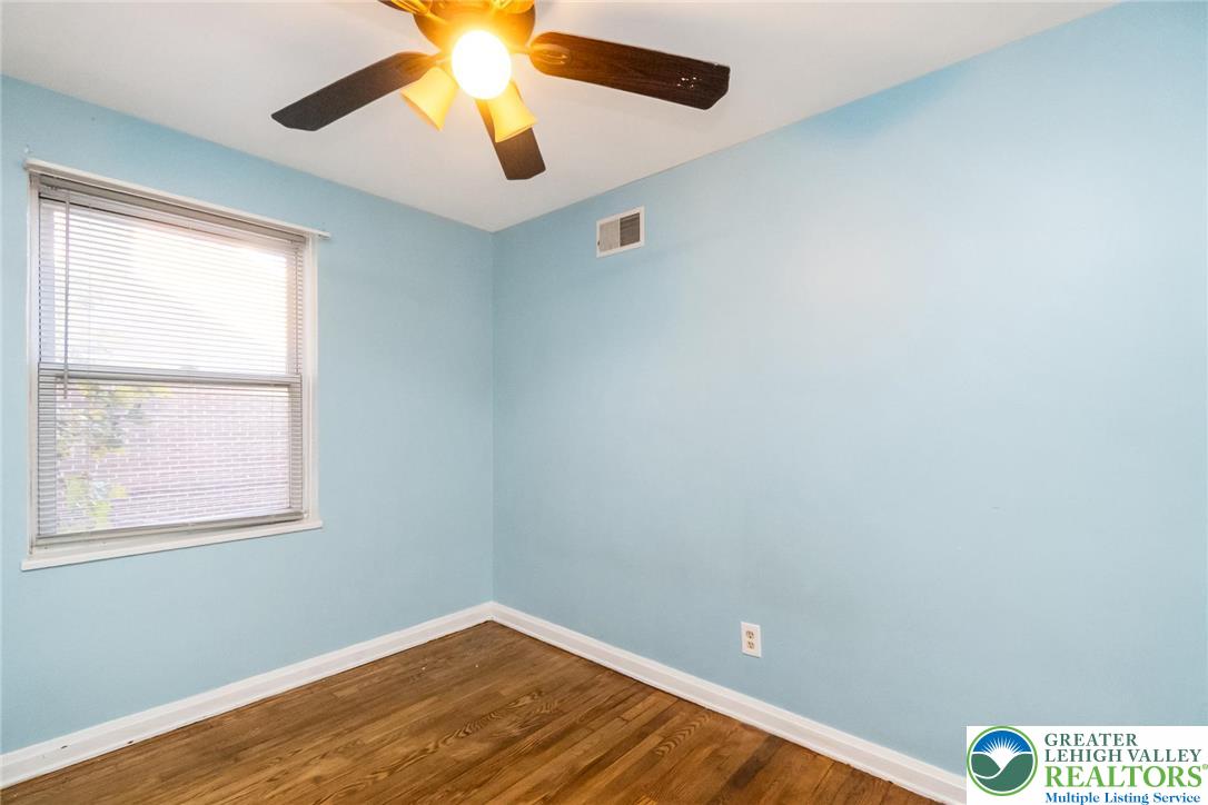 240 Palmer Street Easton, PA 18042 - Photo 26 of 37 an empty room with a window and wooden floor