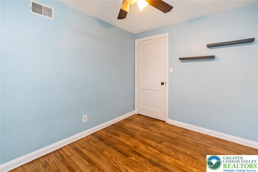 240 Palmer Street Easton, PA 18042 - Photo 27 of 37 an empty room with a ceiling fan and carpet