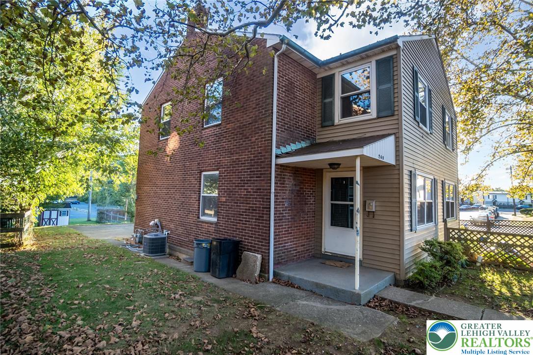 240 Palmer Street Easton, PA 18042 - Photo 5 of 37 a view of a brick house with a yard and large tree