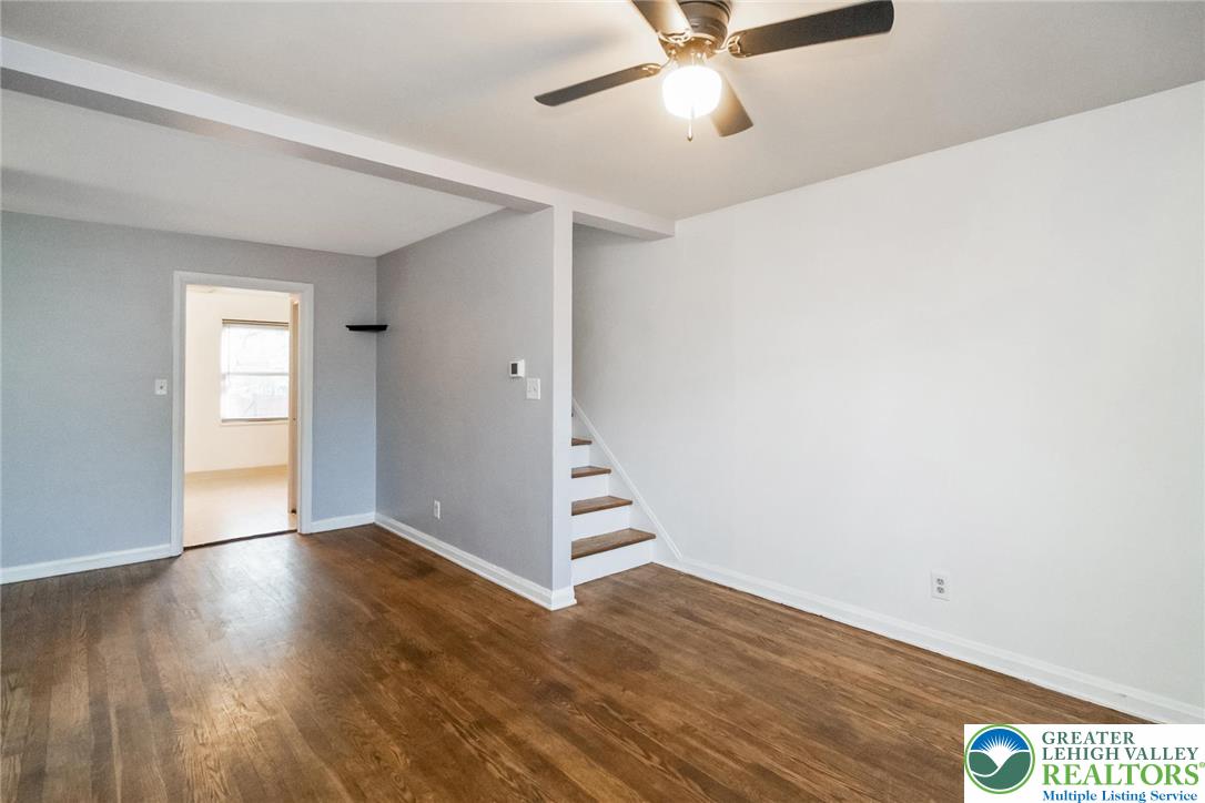 240 Palmer Street Easton, PA 18042 - Photo 6 of 37 an empty room with wooden floor fan and windows