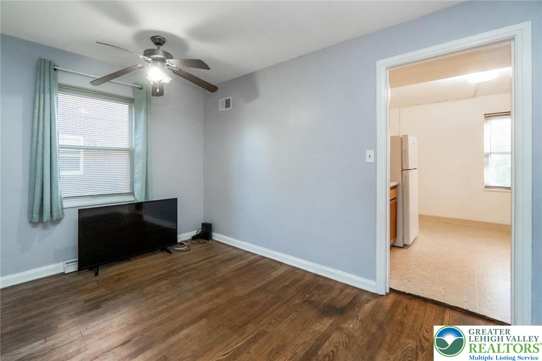 240 Palmer Street Easton, PA 18042 - Photo 9 of 37 an empty room with wooden floor cabinet and windows