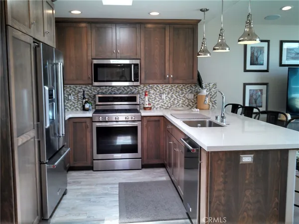 a kitchen with a sink and stainless steel appliances