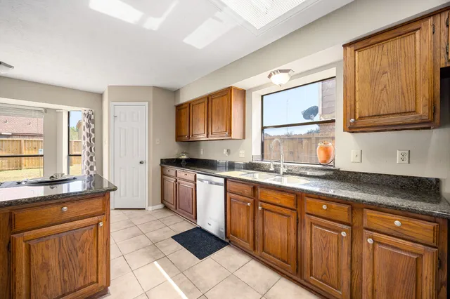 a kitchen with stainless steel appliances granite countertop a sink stove and cabinets