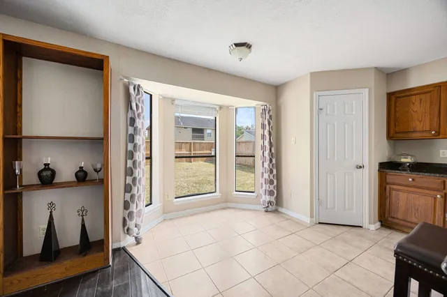 a view of a kitchen and an entryway near an empty room
