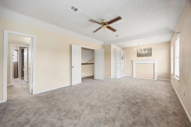 a view of a big room with closet and windows