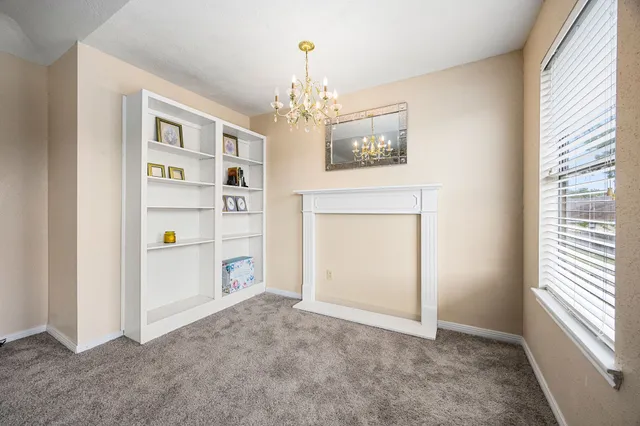 a view of a livingroom with an empty space and a window
