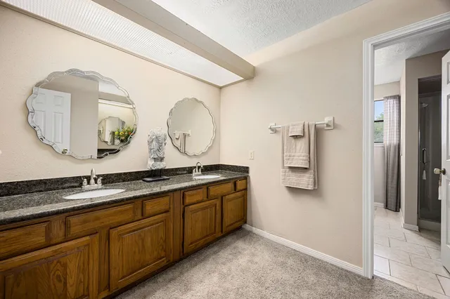 a bathroom with a double vanity sink and a mirror