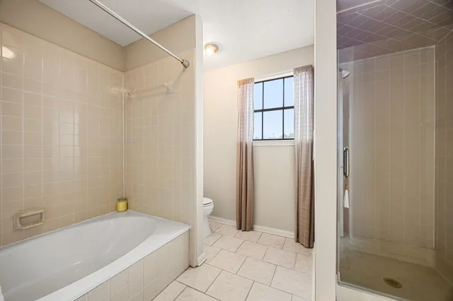 a bathroom with a bathtub and a shower