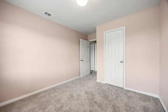 a en suite bathroom with a granite countertop sink and a mirror