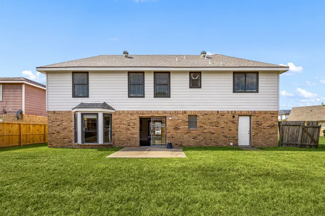 a front view of a house with a yard and porch