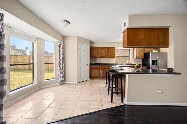 a open kitchen with granite countertop a stove and a sink