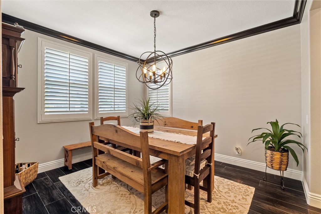 2440 Highwood Road Orange, CA 92867 - Photo 13 of 53 a room with chandelier fan and wooden floor