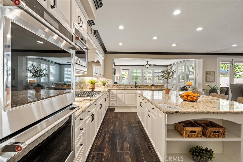 2440 Highwood Road Orange, CA 92867 - Photo 19 of 53 a view of a kitchen with stainless steel appliances granite countertop a stove and a large window