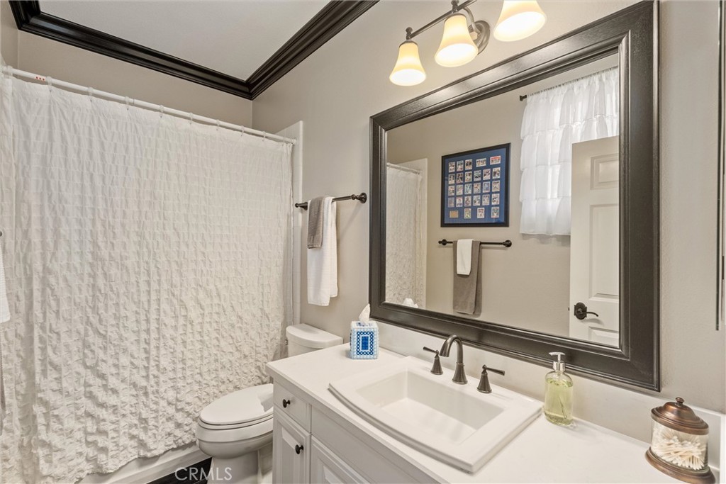 2440 Highwood Road Orange, CA 92867 - Photo 26 of 53 a bathroom with a sink a toilet and shower curtain