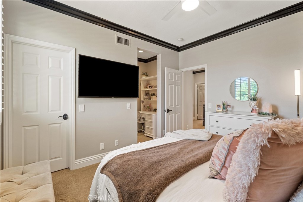 2440 Highwood Road Orange, CA 92867 - Photo 30 of 53 a bedroom with a bed tv and a chandelier