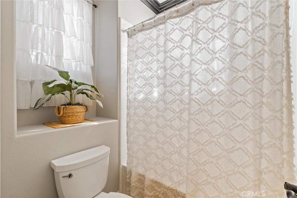 2440 Highwood Road Orange, CA 92867 - Photo 33 of 53 a bathroom with a sink a toilet and curtain