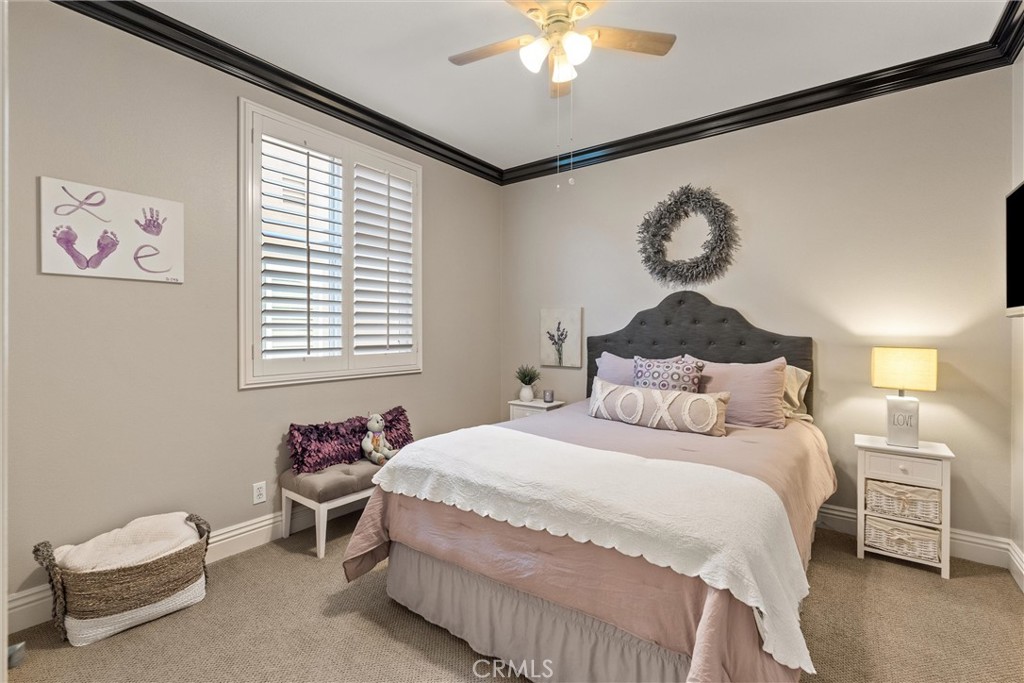 2440 Highwood Road Orange, CA 92867 - Photo 34 of 53 a bedroom with a bed and a chandelier