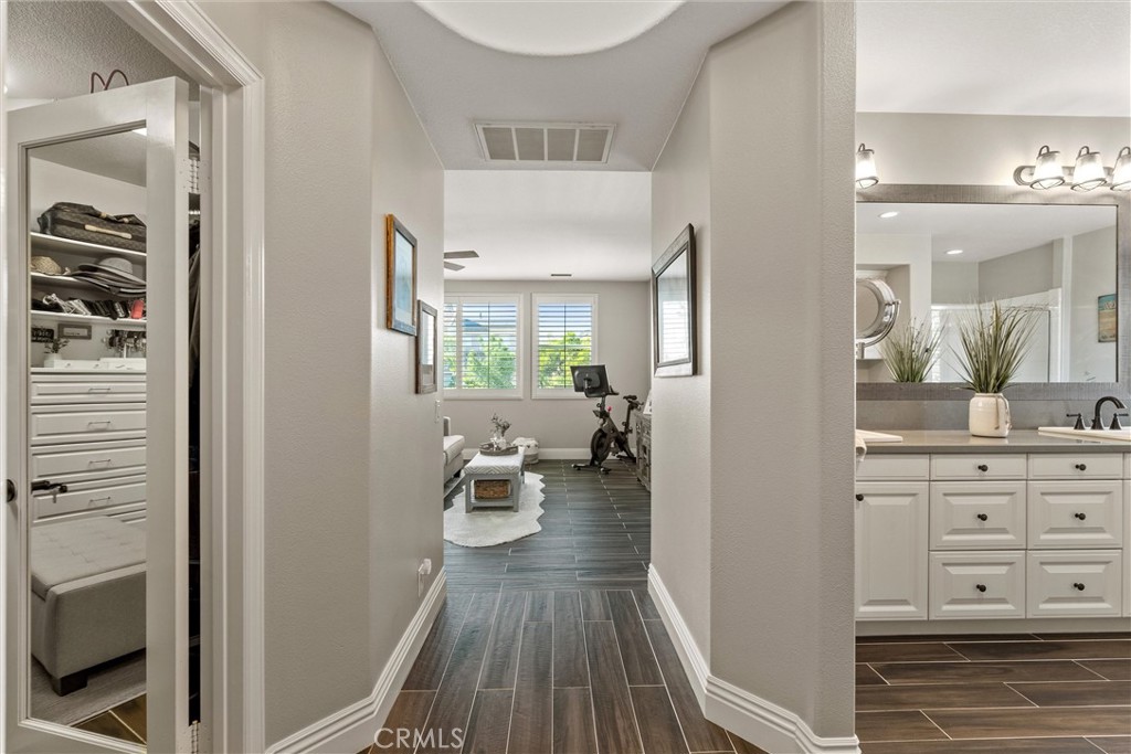 2440 Highwood Road Orange, CA 92867 - Photo 36 of 53 a view of a hallway with couches and wooden floor