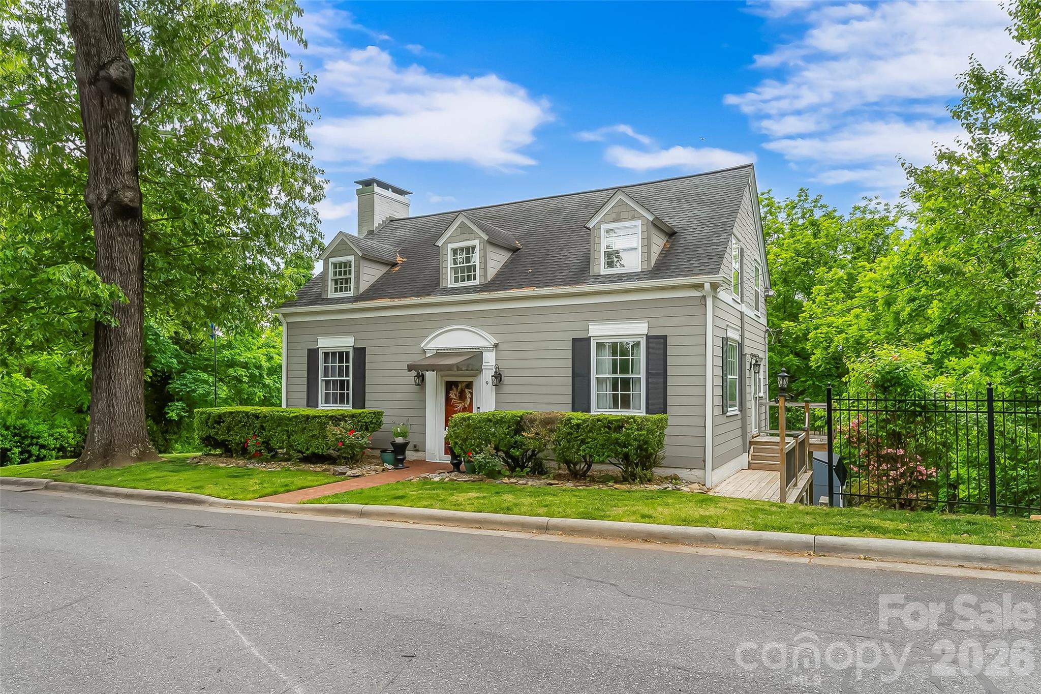 9 Crescent Drive Marion, NC 28752 - Photo 3 of 35 a front view of a house with a yard and large trees