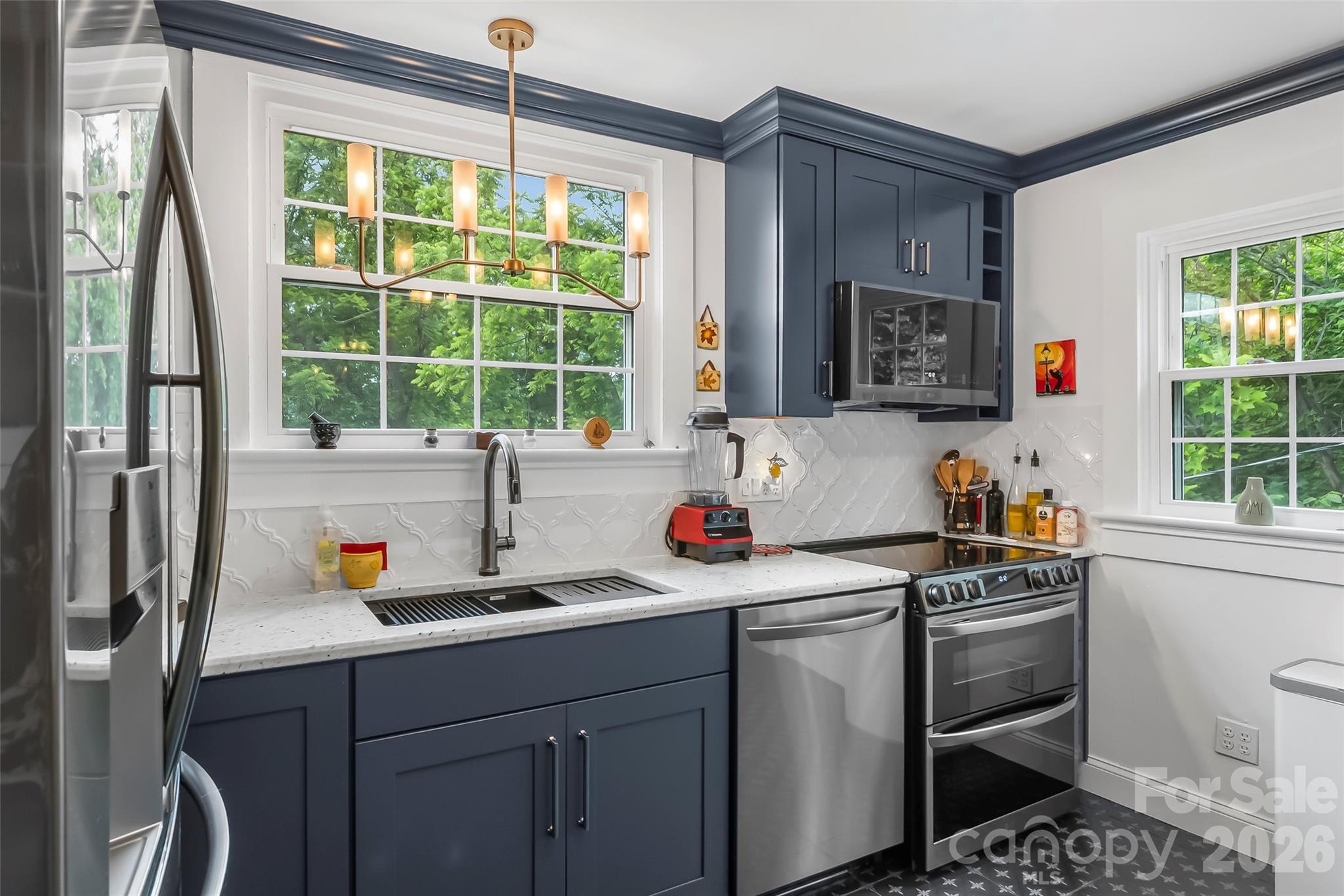 9 Crescent Drive Marion, NC 28752 - Photo 8 of 35 a kitchen with a sink a stove a window and stainless steel appliances